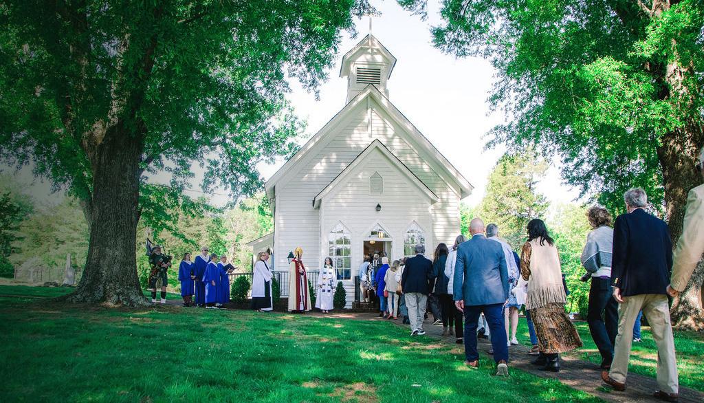 Procession walking toward Grace Episcopal Church during the 150th anniversary celebration