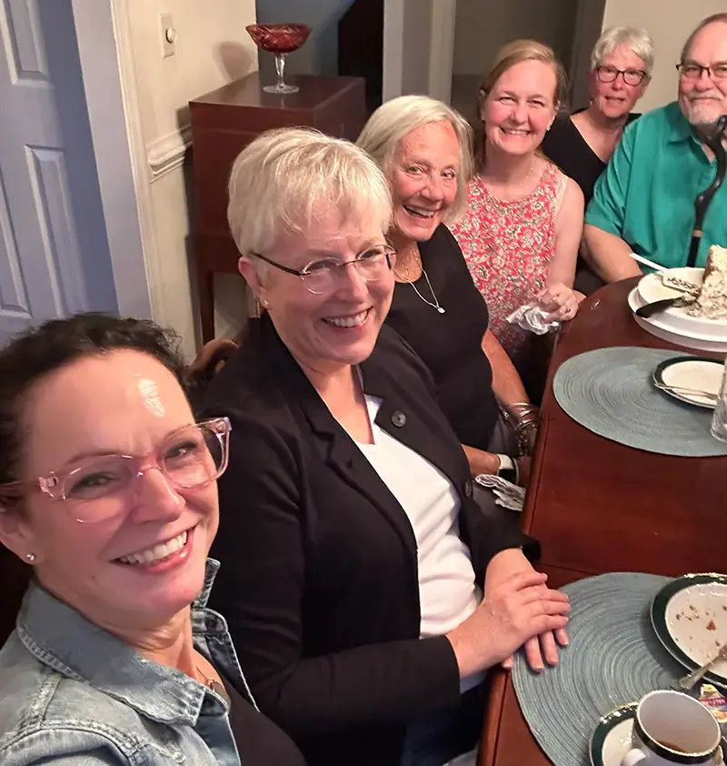 Members of the Community of Hope pastoral care team seated together around a table.